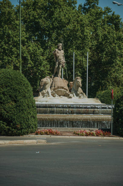 istock Neptune fountain among leafy trees in Madrid 1131826190