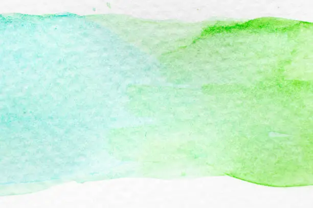 Green and light blue color watercolor handdrawing as brush or banner on white paper background