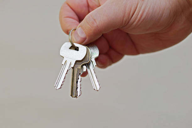 istock closeup of hand giving keys on ring 1131829108