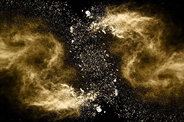 istock Golden powder explosion on black background. Freeze motion. 1131829289