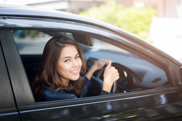 istock Beautiful woman is driving her car 1131829579