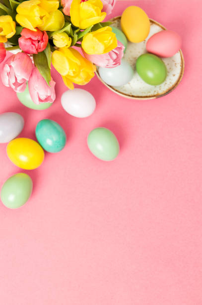 istock Easter eggs tulip flowers pink background decoration 1131831229