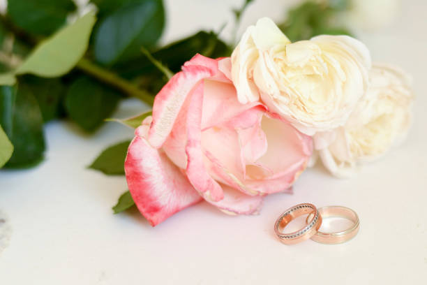 istock wedding rings on flowers background 1131831636