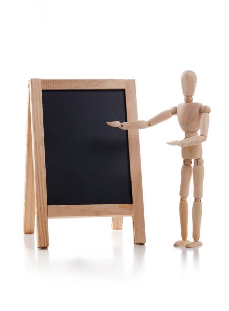 istock Wooden mannequin teaching on blank blackboard isolated on white background 1131831750