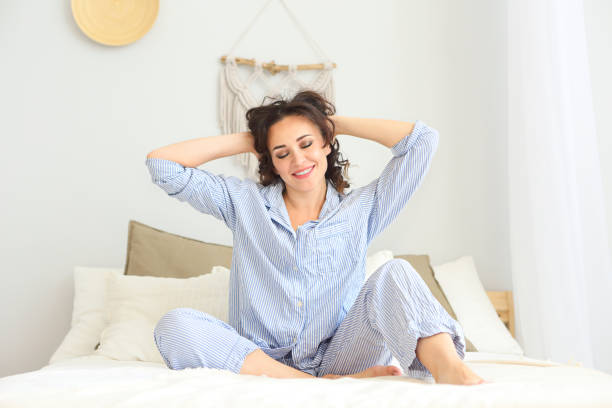 istock Brunette woman in pyjamas resting on bed 1131832716