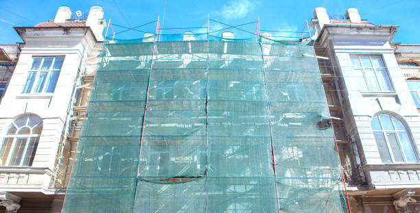 istock scaffolding near a house under construction for external plaster works, high apartment building in city, white wall and window, yellow pipe 1131832824
