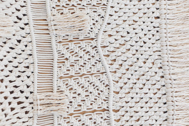 istock Detail of cream macrame decor displayed hanging on a wall. 1131833286