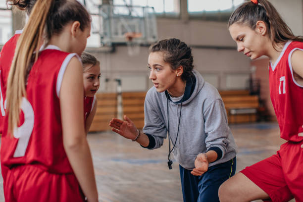 istock Female coach with basketball team 1131834268