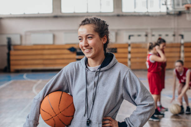 istock Female coach with basketball team 1131834377