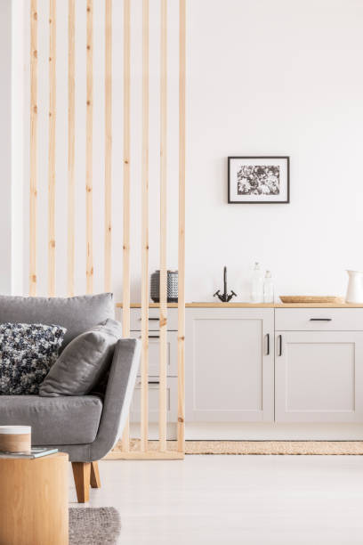 istock Wooden mullins wall in bright open plan studio apartment with kitchen and living room 1131834665