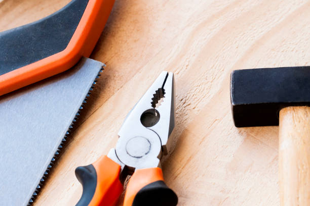 istock Hammer, nails and pliers lie on a wooden background. Construction Tools Selective Focus. 1131834730