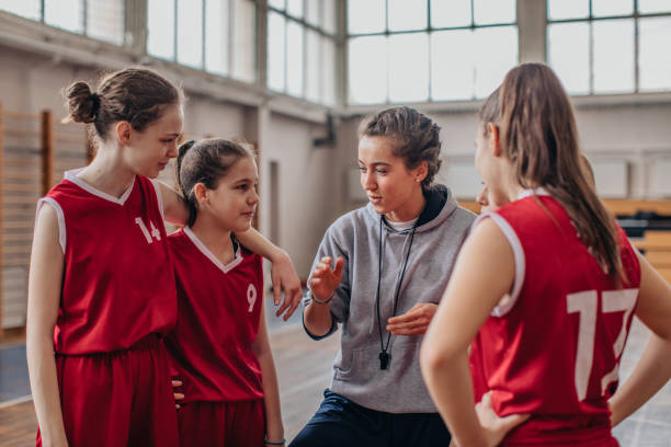 istock Female coach with basketball team 1131834765