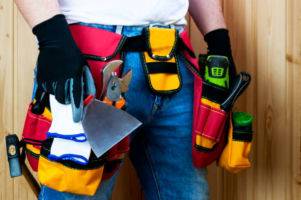 istock Tools in the belt for tools. The builder holds a spatula in his hand. Selective focus. 1131834790