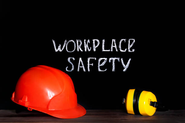istock Construction helmet on a black background with the inscription workplace safety . Safety concept 1131834837