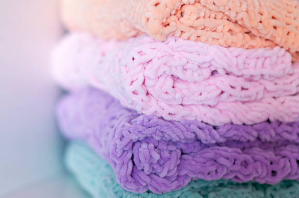 A few bright colored knitting needles bedspreads or blankets. Comfort, homely warmth. Selective focus