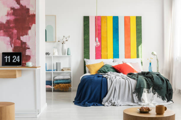 istock Modern, open space apartment interior with a home office in the foreground and a bedroom with a colorful bedhead in the background. Real photo 1131835112