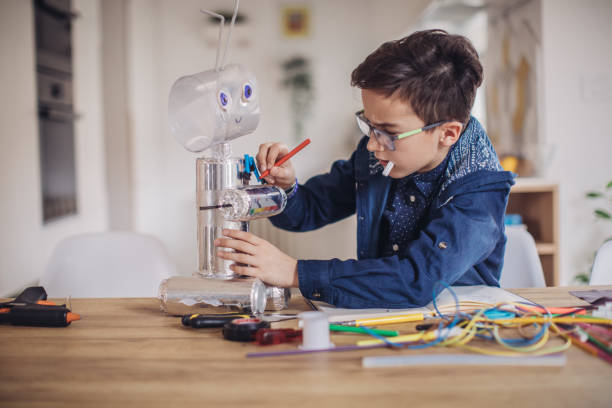 istock Little boy making robot toy for school project 1131837293