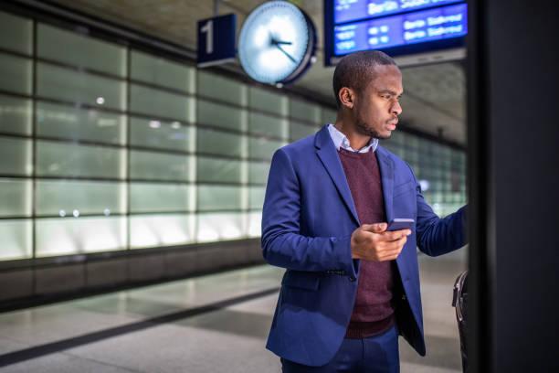 Traveling businessman buying a train ticket