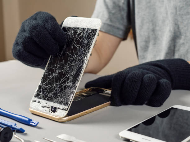 istock Technician repairing broken smartphone on desk 1131838785