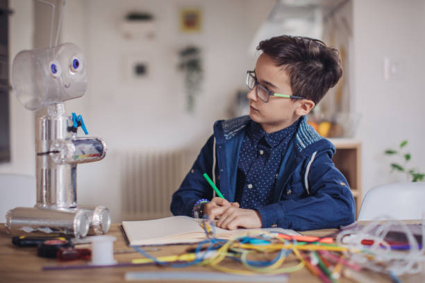 istock Little boy making robot toy for school project 1131838877