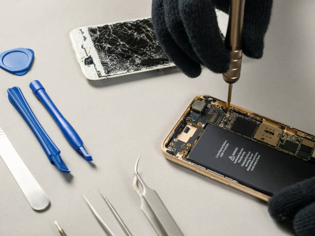 istock Technician repairing broken smartphone on desk 1131839654