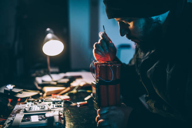 Man making bomb Man making time bomb at night terrorist stock pictures, royalty-free photos & images