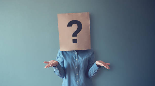 Woman has Confused, Thinking, Question Mark Icon on Paper Bag, copy space. Woman has Confused, Thinking, Question Mark Icon on Paper Bag, copy space. mask disguise photos stock pictures, royalty-free photos & images