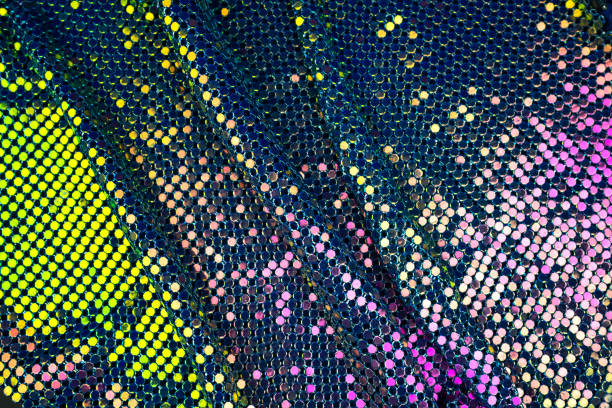 istock Abstract background with gold, green and purple sequins on the fabric. 1131841870