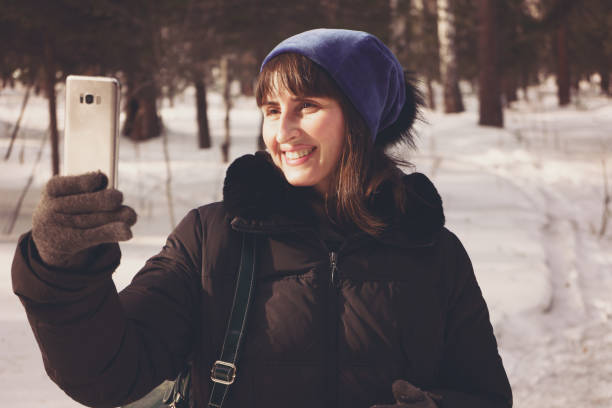 istock Woman using mobile phone in wintertime 1131842440