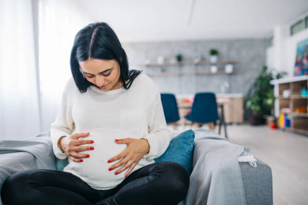 istock Pregnant woman holding her belly 1131845122