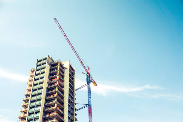 istock Modern building construction. Modern high block of flats and a construction crane. 1131846552