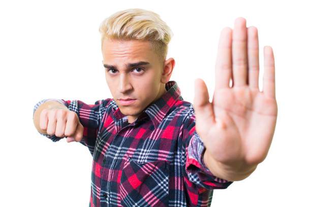 istock guy in shirt shows stop sign with his hand 1131847557