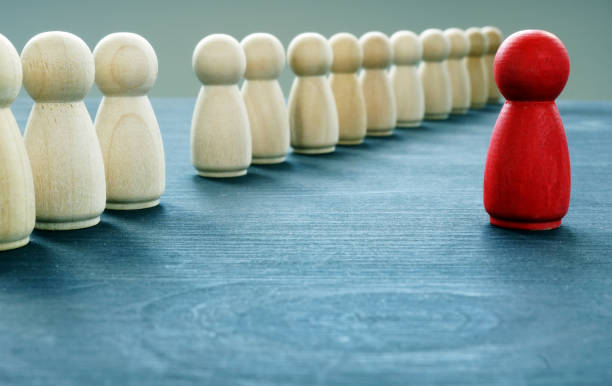 istock Be unique and different. Red figurine is stand out from the crowd. 1131847687