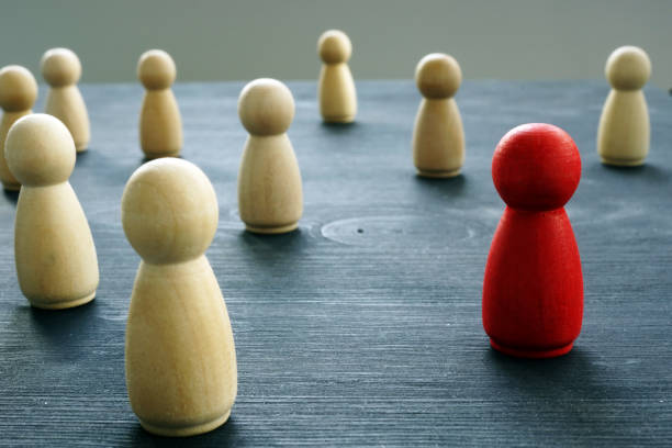 istock Crowd of figurines with red one. Uniqueness and Individuality. 1131847782