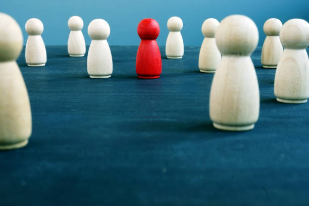 istock Crowd of figurines and red one. Difference and uniqueness concept. 1131847829