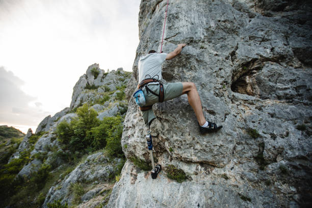 istock Disability young man free rock climbing 1131848446