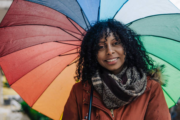 istock Young Afro-American woman with umbrella 1131848449