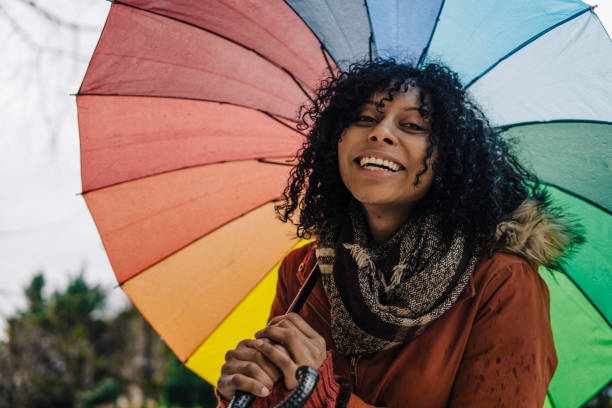 istock Young Afro-American woman with umbrella 1131848508