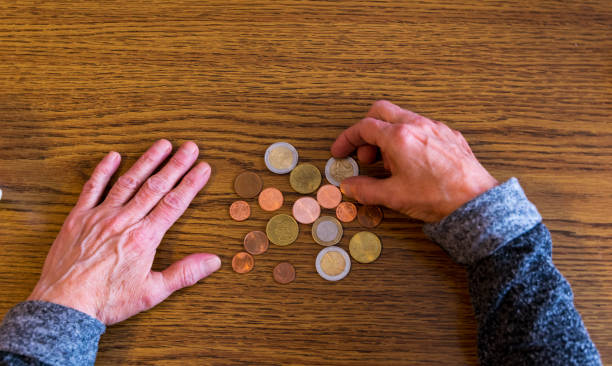 istock Poor old woman is counting down her last change 1131848515