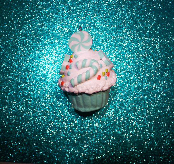 Blue cupcake on a glistening blue bokeh background. Food minimal concept. Top view.