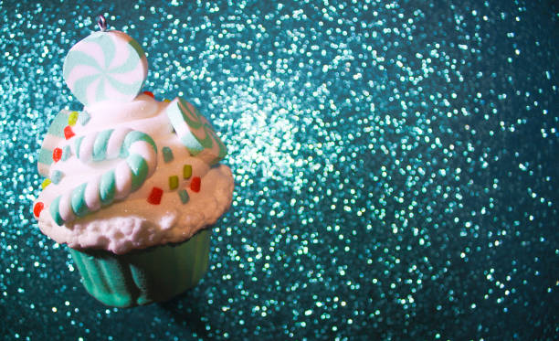 istock Blue cupcake on a glistening blue bokeh background. 1131849241