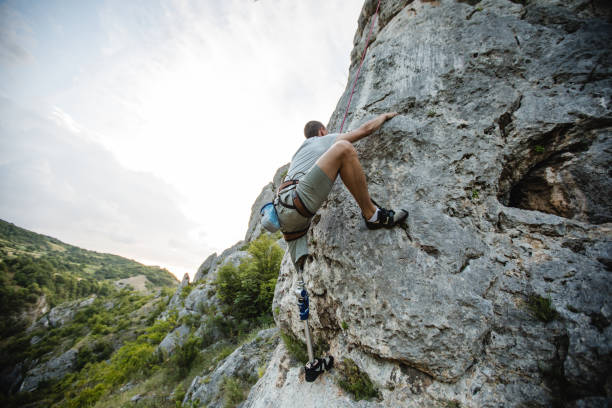 istock Disability young man free rock climbing 1131850258