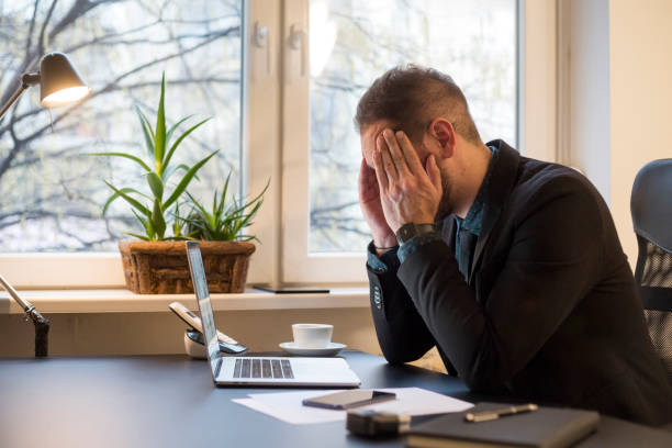 istock businessman working on laptop in office eyes hurt 1131850329