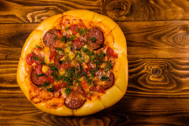 istock Fresh homemade pizza on a wooden table. Top view 1131854717