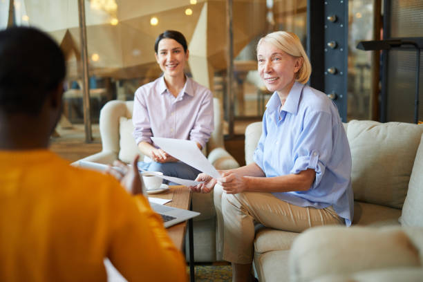 istock Cheerful confident startup partners sitting in modern cafe and discussing ideas and projects together during meeting 1131854756