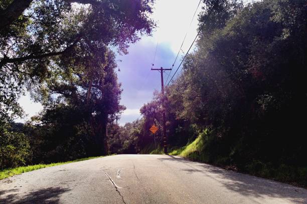 istock Country Road with Storm Clouds and Sunlight In the Valley 1131858719