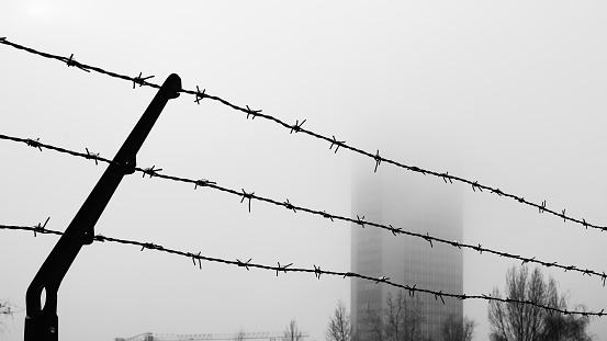 Barbed wire and building fog