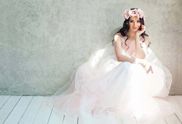 Beautiful bride woman in tulle roses wedding dress, lifestyle portrait Beautiful bride woman in tulle roses wedding dress, lifestyle portrait evening gown photos stock pictures, royalty-free photos & images