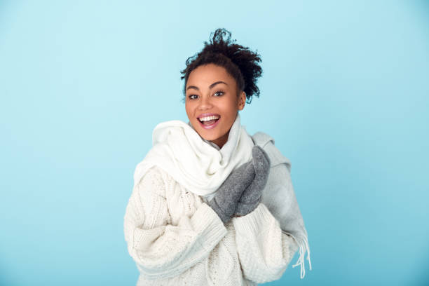istock Young african woman isolated on blue wall studio winter concept laughing 1131862947