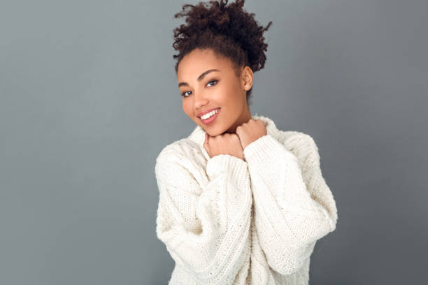 istock Young african woman isolated on grey wall studio winter concept happiness 1131863126
